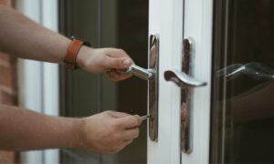 hands unlocking doors after rekeying by Houston building maintenance